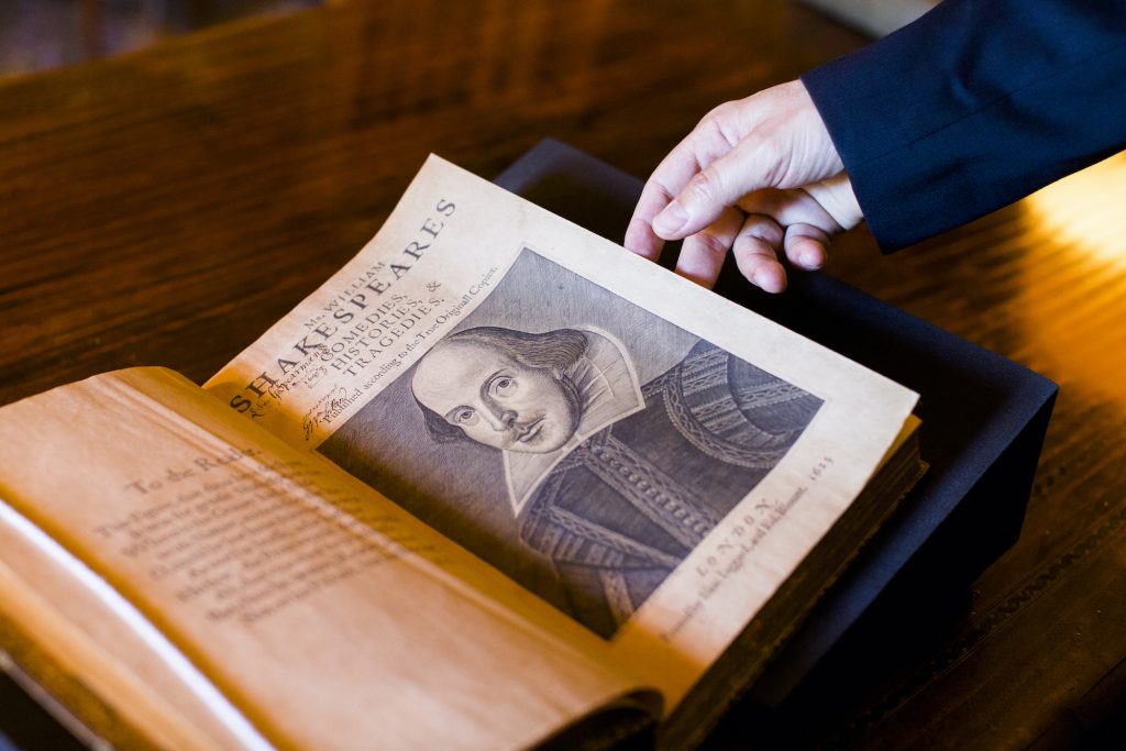 Photo of an old book that is opened to a page with a drawing of Shakespeare, dated 1611.