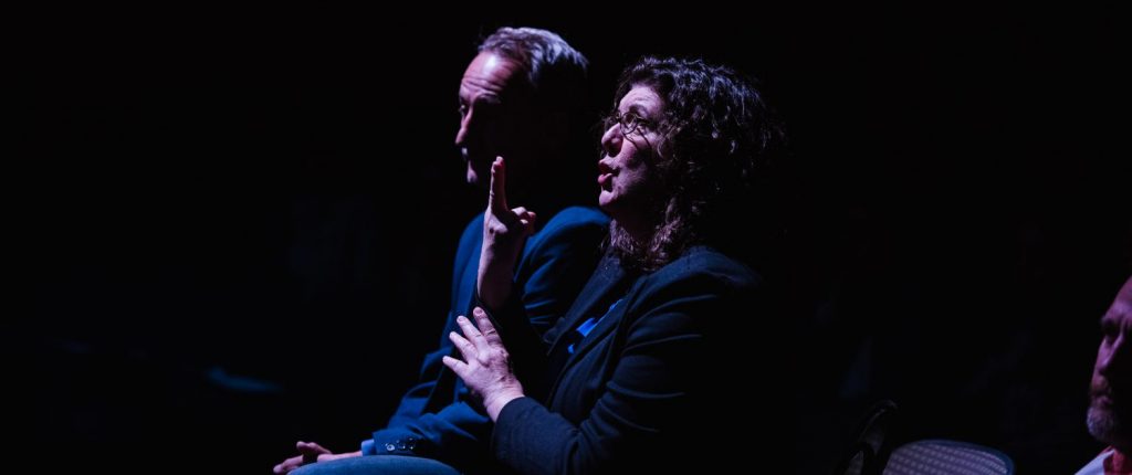 Two ASL interpreters signing for the keynote address of DJ Kurs, Artistic Director for Deaf West Theatre. Photo credit: Stanley Wu