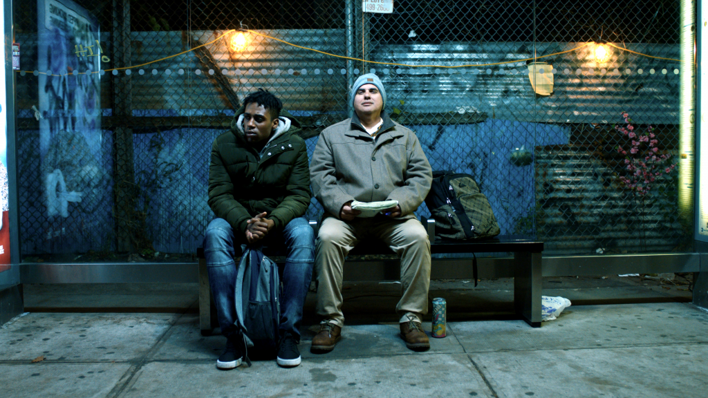 Two people sitting side-by-side on a bench.