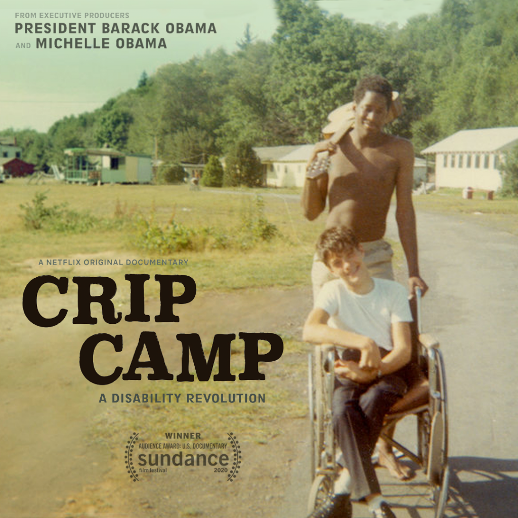 A film cover of Crip Camp. A darkksin man holding a guitar over his right shoulders and one had placed on a wheelchair with a boy sitting on it.