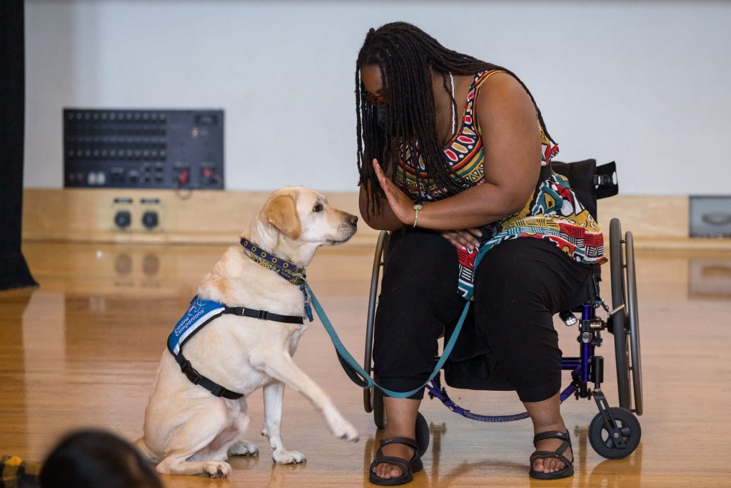 India Harville with her service dog participating in the shared group dance jam.