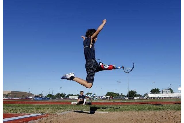 Ezra Frech, 10, does the long jump. He was his Bruin father's inspiration for launching a Paralympic-style competition at UCLA for disabled athletes of all ages and abilities. Courtesy Clayton Frech