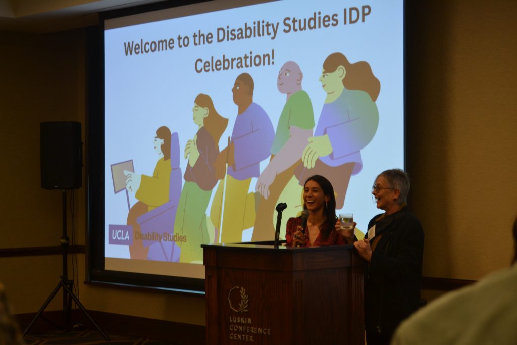 Photo of Dean of Undergraduate Education, Adriana Galvan, and Chair of Disability Studies, Professor Victoria Marks, raising a toast to the launch of the Disability Studies BA degree.