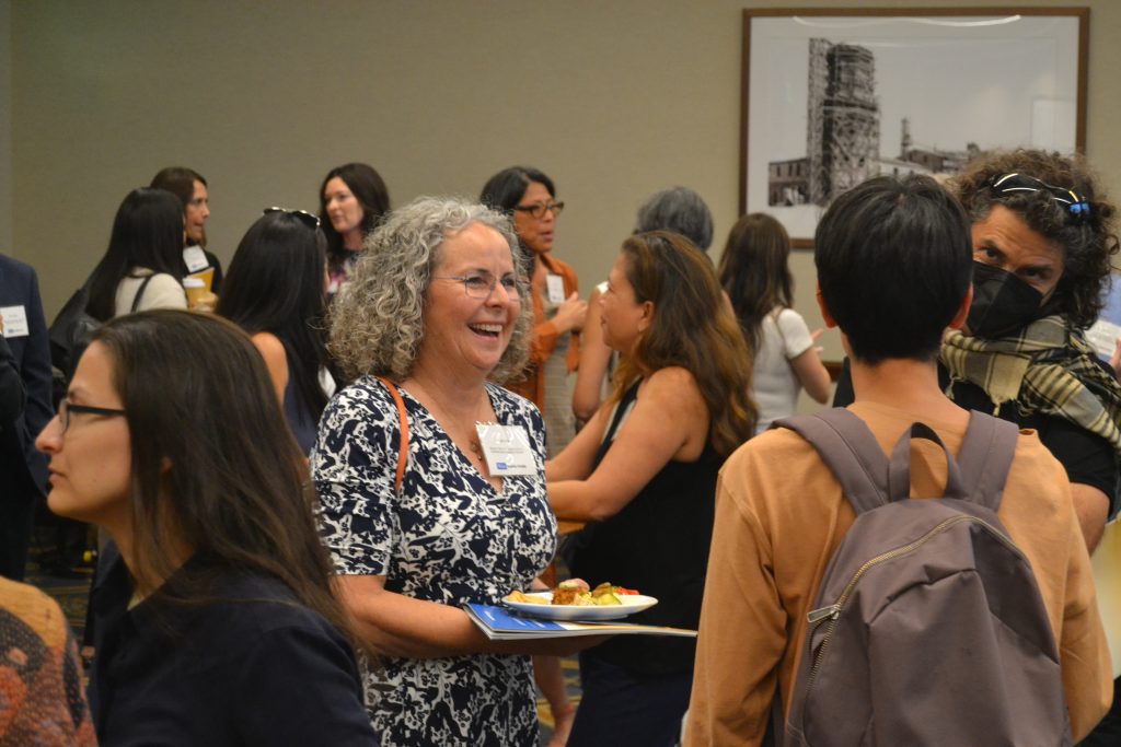 A photo of Dr. Lauren Clark engaging in conversation at the reception.