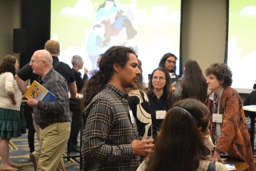 A photo of Dr. Fred Ariel Hernandez engaging in conversation during the reception.