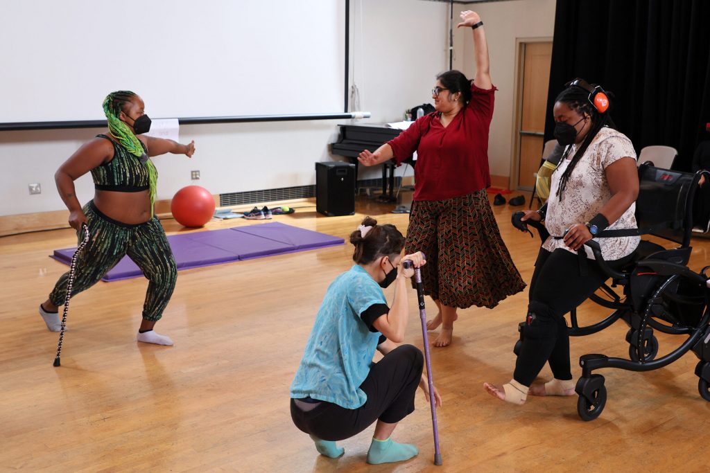 A photo of four disabled dancers in movement.