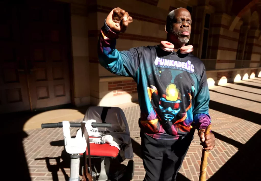 Disabled scholar and community activist Leroy Moore raises a fist in support of disability rights on the UCLA campus. Moore, a doctoral student in anthropology at the school, was born with cerebral palsy and has dedicated much of his writing and activism to disability rights. (Genaro Molina / Los Angeles Times)
