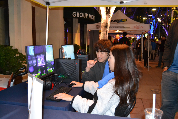 Two students check out Blizzard Entertainment’s adaptive gaming set-up, getting the exciting opportunity to play and test out accessibility features in a video game onscreen.