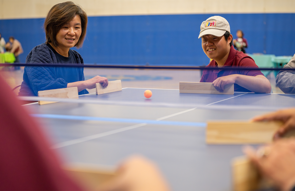 A woman and man play a game of Takkyu Volley.