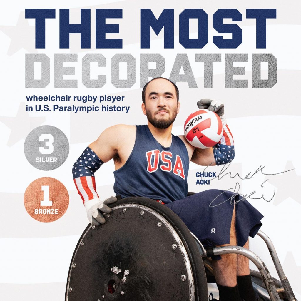 A portrait of Chuck Aoki, a decorated U.S. Paralympic wheelchair rugby player, holding a rugby ball. He is wearing a navy blue USA jersey and patriotic arm sleeves with stars and stripes. The text above him reads "The Most Decorated" in large letters, with "wheelchair rugby player in U.S. Paralympic history" written below. To the left, there are graphics indicating his medals: 3 silver and 1 bronze. The United States Paralympic Team logo is at the bottom left.