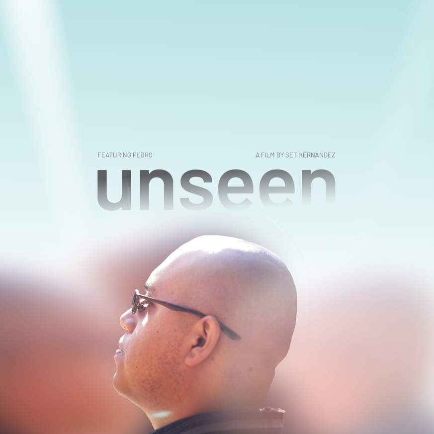 A bald young man appears in-focus, amidst hazy ﬁgures surrounding him. He wears glasses while looking up to the endless bright sky above him, his expression pensive. As the sky meets the young man’s head in the middle of the poster, the ﬁlm’s title appears: unseen.