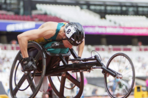 Sam McIntosh in a racing chair on a track.