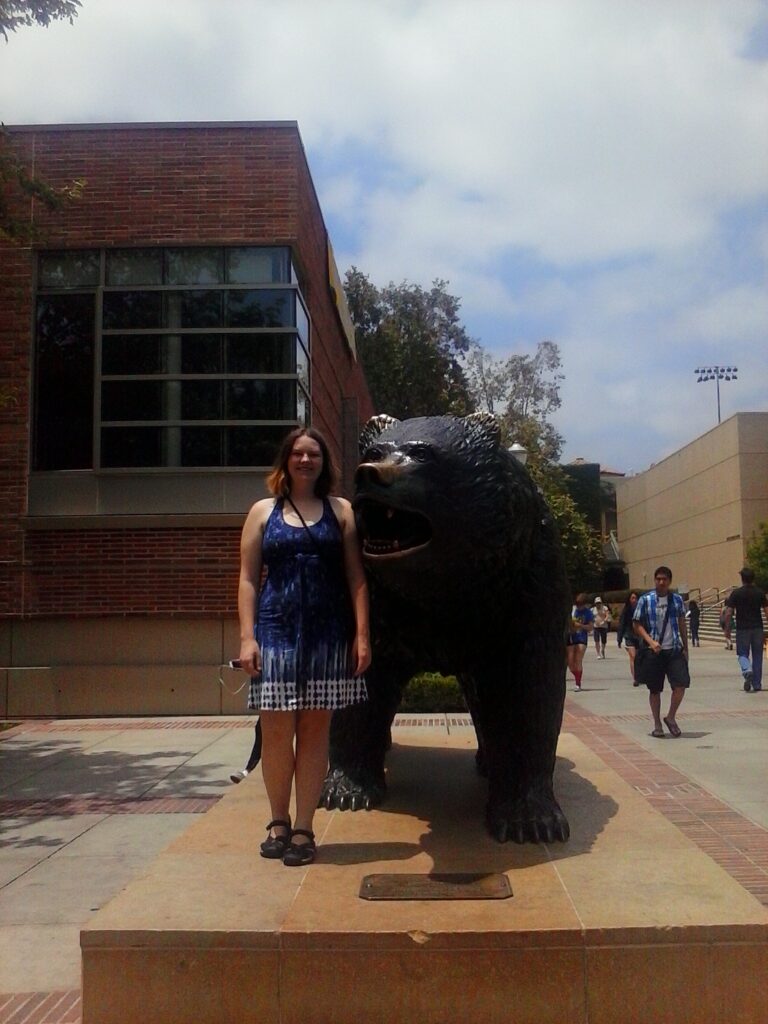 Avril Frasché poses with the Bruin Bear during the day.
