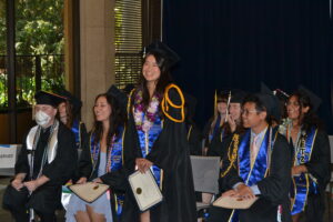 Scholarship winner Jessica Le stands to accept her scholarship certificate. 